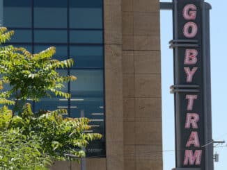 Go By Tram sign